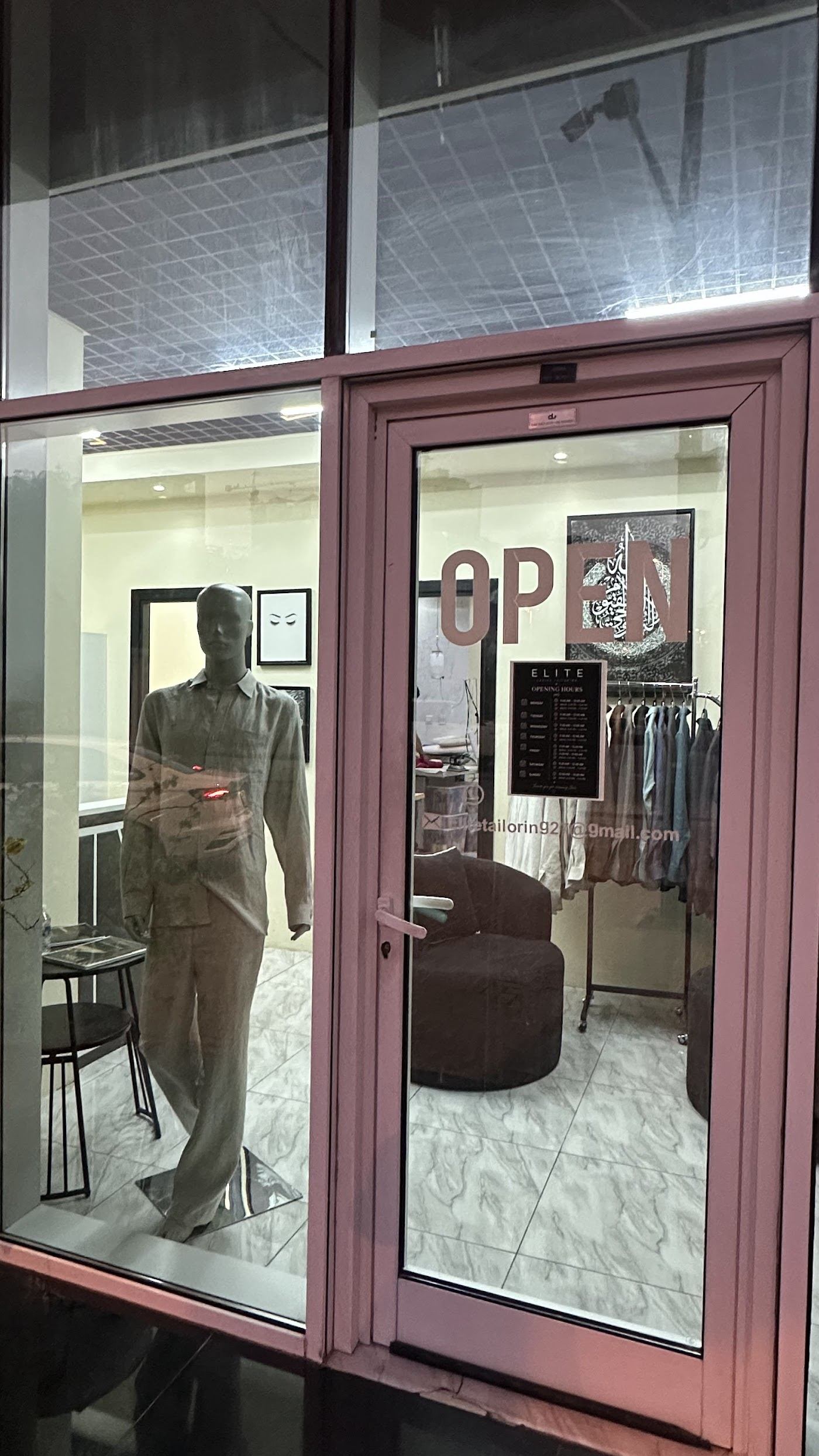 Shop window at Elite Tailoring with mannequin